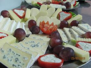 a bunch of different types of cheese and grapes at Residenza Dutzu-Boutique Hotel in Brăila