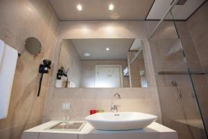 a bathroom with a sink and a mirror at Best Western Plus Net Tower Hotel Padova in Padova