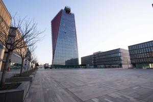 a tall skyscraper in the middle of a city at Best Western Plus Net Tower Hotel Padova in Padova