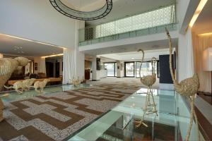 a living room with a lobby with a large rug at Devero Hotel BW Signature Collection in Cavenago di Brianza