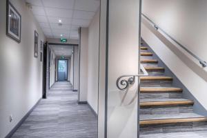 een gang van een kantoorgebouw met trappen bij Best Western Hotel Ile de France in Château-Thierry