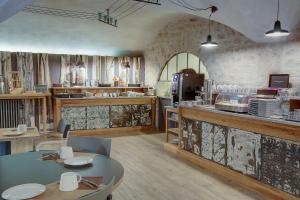 a restaurant with a table and a kitchen with a counter at Best Western Citadelle in Besançon