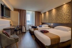 A bed or beds in a room at Best Western Plus Hotel Farnese