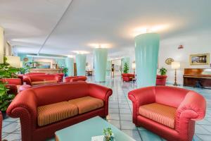 a waiting room with red chairs and a table at Best Western Hotel La Solara in Sorrento