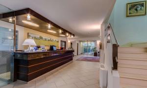 a hotel lobby with a reception desk and stairs at Best Western City Hotel in Bologna