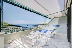a balcony with a table and chairs and the ocean at Best Western Hotel La Solara in Sorrento
