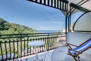 a balcony with a table and chairs and a view of the ocean at Best Western Hotel La Solara in Sorrento