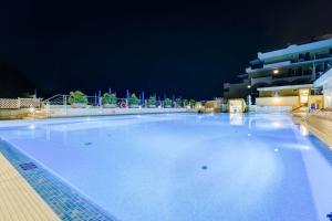 a large swimming pool at a hotel at night at Best Western Hotel La Solara in Sorrento