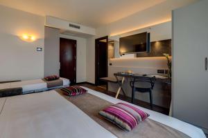 A bed or beds in a room at Best Western Plus Hotel Farnese