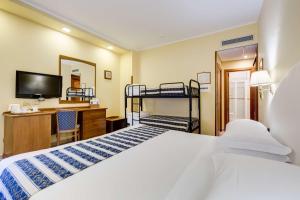 a bedroom with two bunk beds and a desk at Best Western Hotel La Solara in Sorrento