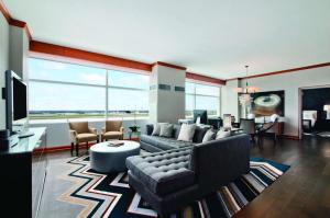 a living room with a couch and a tv at Grand Hyatt DFW Airport in Irving