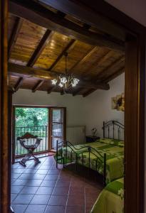 a bedroom with two beds and a balcony at I 3 Porcellini in Cutigliano