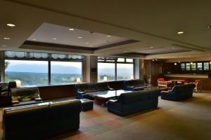 un ampio soggiorno con divani, tavoli e finestre di Tateshina Park Hotel a Chino