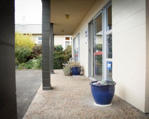two large blue pots sitting outside of a building at Alpine Motel in Oamaru