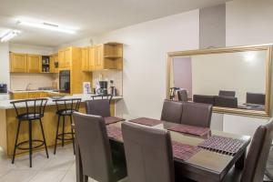 a kitchen and dining room with a table and chairs at Sand & Sea Holiday Home in Swakopmund
