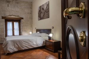 a bedroom with a white bed and a window at Hotel Residenza Petra in Petralia Soprana