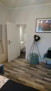 a living room with a black lamp and a chair at Tawerna Rybaki Old Town in Gdańsk