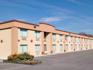 a large building with a lot of windows in a parking lot at Express Inn Harrisburg South New Cumberland in New Cumberland