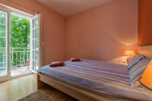 Katil atau katil-katil dalam bilik di Emona Apartments, Bled
