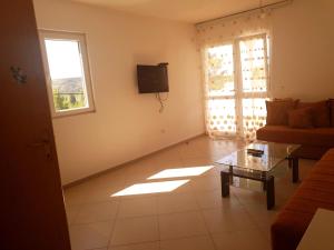 a living room with a couch and a table at Aparmani Family 1 in Sutomore