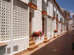 a street with flowers on the walls of a building at Terraced House - Zand Properties in Benidorm