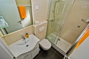 a bathroom with a sink and a shower and a toilet at Apartments Dorijan in Beautiful House in Hvar