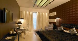 a bedroom with a large bed and a large window at The Zuri Whitefield Bengaluru in Bangalore