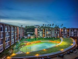 an apartment complex with a tennis court in the middle at Replay Condo Studio Room in Bangrak Beach