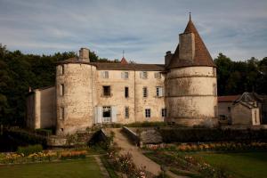 an old castle with a garden in front of it at Château des Martinanches in Saint-Dier-dʼAuvergne
