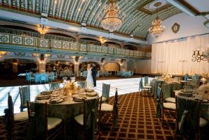 a bride and groom standing in the middle of a banquet hall at Millennium Knickerbocker Chicago in Chicago