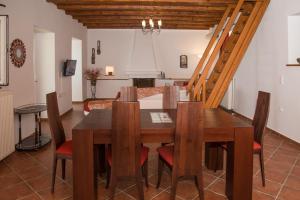 a dining room with a wooden table and chairs at Olea Escape Villa in an Olive Estate in Gythio