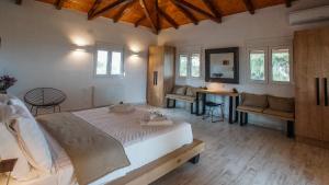 a bedroom with a large bed and a table and chairs at Olea Escape Villa in an Olive Estate in Gythio
