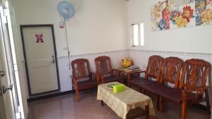 a room with four chairs and a table and a door at Scarecrow Homestay in Jincheng +12 photos