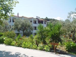 a white building with a garden in front of it at Villa Maro in Skopelos Town