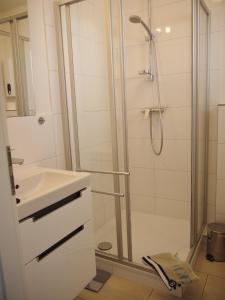 a bathroom with a shower and a sink at Oceanbreeze in Scharbeutz +10 photos