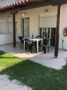 a patio with a table and chairs on it at Apartments Gregory & George in Hanioti