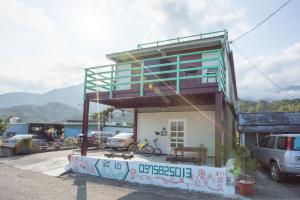 a small house with a balcony on top of it at Babian Bed and Breakfast in Chenggong