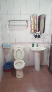 a bathroom with a toilet and a sink at Scarecrow Homestay in Jincheng