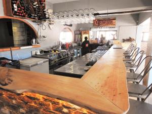 a long counter in a kitchen with a long bar at Pili Pili Beach Cabanas in Sedgefield