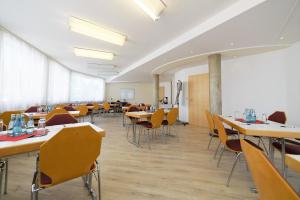 a classroom with tables and chairs in a room at Hotel Best one in Roßdorf