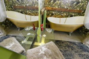 a bathroom with two sinks and two tubs at Bett _ Bike Romantik _ FH Odin in Großräschen +18 photos