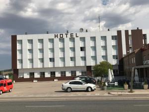 a hotel with cars parked in front of it at Hotel Buenos Aires in Villafría de Burgos