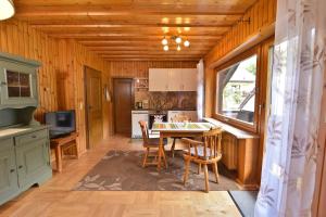 a kitchen and dining room with a table and chairs at Ferienwohnung Waldheimat in Bayerisch Eisenstein