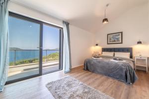 a bedroom with a bed and a large window at Apartmani D & J in Orasac +153 photos