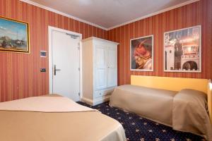 Postel nebo postele na pokoji v ubytování Holiday Rooms Antica Badia