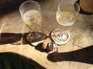 two wine glasses sitting on top of a wooden table at Cabane Écureuil & Cabane Chevreuil in Fournes-Cabardès