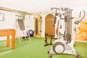 a room with a gym with a treadmill and a table at Schlossberghof in Marktrodach +34 photos
