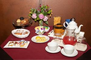 a table topped with plates of food and pitchers of tea at La Torre-1984 in Sarnelli