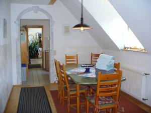 a dining room with a table and chairs at Schlossberghof in Marktrodach