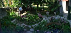 a garden with flowers and plants in a yard at Veronauptoyou Apartments in Verona